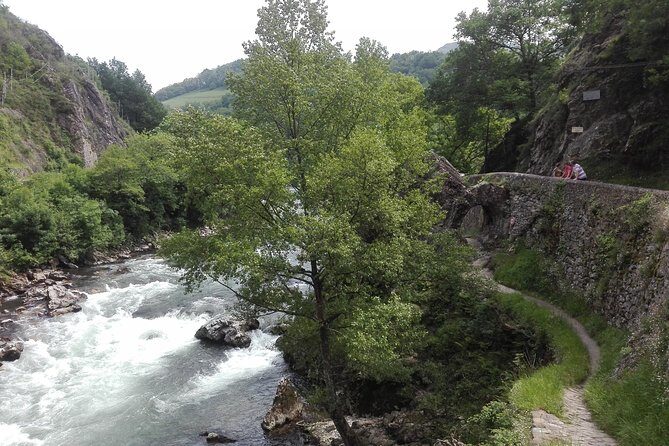 Private French Basque Countryside & Villages from San Sebastian - Bidarray: pink stone, a porch for rain, and the River Nive leads the way